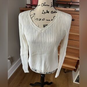 TH V-neck ribbed cream sweater with a silver sipper on left side.